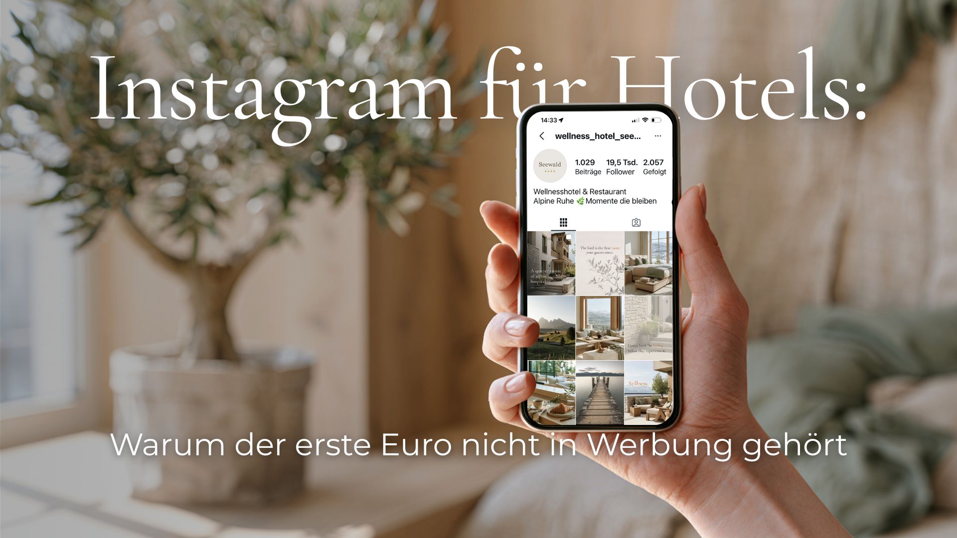 Eine Hand hält ein Smartphone mit einem ruhigen, hochwertigen Hotel-Feed.